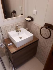 a bathroom with a white sink and a mirror at Guesthouse Mare Bar in Bar