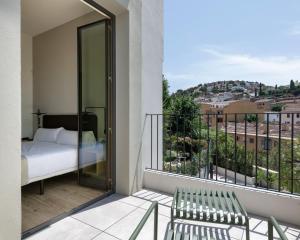 a bedroom with a bed and a balcony with a view at Alta House Begur in Begur