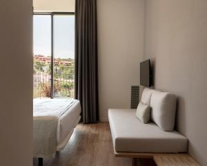a hotel room with a bed and a window at Alta House Begur in Begur