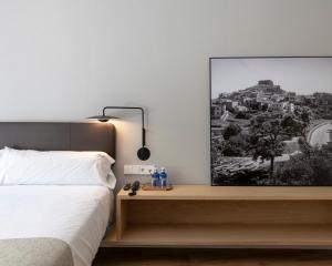a bedroom with a bed and a picture on the wall at Alta House Begur in Begur