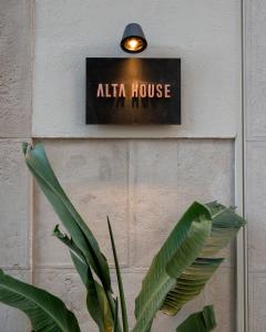 a plant in front of aallo house sign on a wall at Alta House Begur in Begur