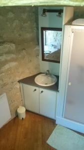 a bathroom with a sink and a mirror at Moulin De Rouzé in Castelnaud-de-Gratecambe