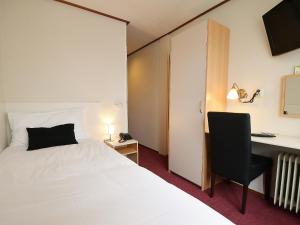 Postel nebo postele na pokoji v ubytování Hotel Faber