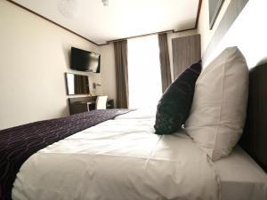 Postel nebo postele na pokoji v ubytování Hotel Faber