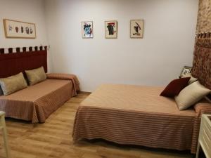 Postel nebo postele na pokoji v ubytování Hostal Maestre