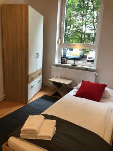a bedroom with a large bed with a window at havenhome Bremerhaven in Bremerhaven