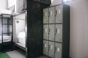 a group of lockers in a room with a bed at Mellow Hostel in Kuta Lombok