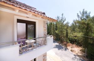 a view from the balcony of a house with a view at Villa Ermioni Apartments in Limenaria