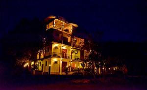 a large white building with lights on it at night at Green View Resort - Anuradhapura in Anuradhapura
