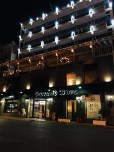 a large building with lights on the front of it at Cavo D' Oro in Piraeus