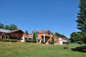 a group of houses on a grassy field at Village vacances Chalet de la Haute-Joux in Cerniébaud