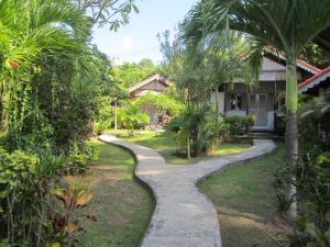 a walkway in the yard of a house at Kembali Beach Bungalows in Amed