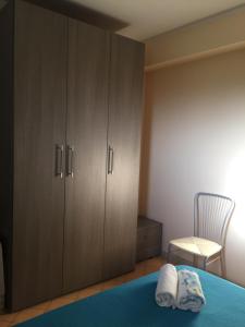 a bedroom with a cabinet and two pillows on a bed at Valentina Holiday House in Mascali