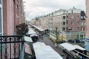 a city street with a market with stalls and buildings at The Market Retreat in Amsterdam