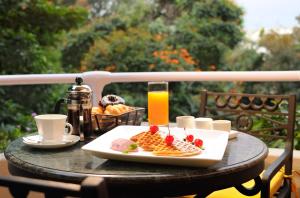 a table with a plate of food and a glass of orange juice at The Oberoi Bengaluru in Bengaluru