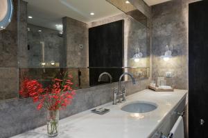 a bathroom with a large mirror and a sink at D Resort Gocek Special Category in Göcek
