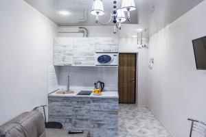 a small kitchen with a sink and a microwave at Smart apartment проспект Гагарина in Dnipro
