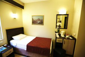 a hotel room with a bed and a mirror at Boğaz Otel in Çanakkale +22 photos