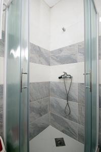 a shower with a glass door in a bathroom at Apartments Mirko in Ulcinj +64 photos
