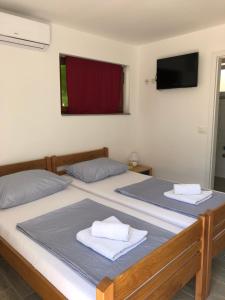two beds in a room with two towels on them at Apartment Patrizia in Zadar