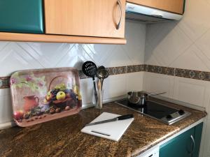 a kitchen counter with a stove and a box on it at Damas 3 in Cáceres