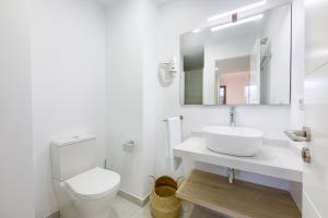 a white bathroom with a sink and a toilet at Plaza de La Feria Premium Apartments in Las Palmas de Gran Canaria +16 photos