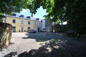 a car parked in front of a large building at The Lawns House in Holt +7 photos