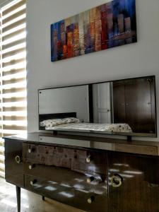 a mirror on top of a dresser in a room at Charming Rooms with a Seaview in Sliema