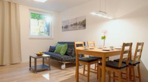 a living room with a table and a couch at Ferienwohnung Mittelsberg in Konstanz
