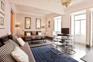 a living room with a couch and a table at Apartments of the Marques in Lisbon