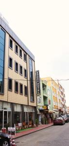 a row of buildings on a city street with cars at Canakkale Bogaz Hotel in Canakkale