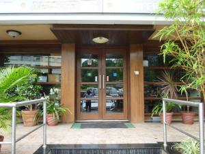 a front door of a building with potted plants at Hotel Atria, Kolhapur- Opposite To Central Bus Station in Kolhapur