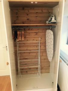 a walk in closet with a wooden wall at 83 Downs Hill in Beckenham