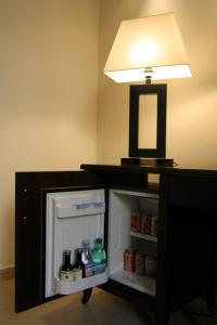 a small refrigerator with a light on top of it at Hotel Garda in Rome