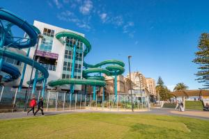 a water slide in front of a building at "Ocean Sunset" Glenelg Central Studios in Adelaide