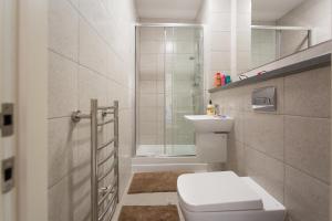 a white bathroom with a toilet and a shower at The Nest in Sheffield +41 photos