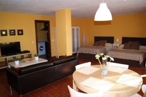 a living room with a couch and a table at Villa Balcon del Duque in Zahara de los Atunes