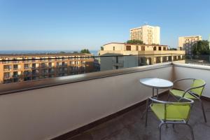 un balcón con 2 sillas y una mesa. en Tomis Garden Aparthotel Mamaia, en Mamaia