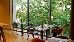 a restaurant with tables and chairs and a large window at Katholisch-Soziales Institut in Siegburg