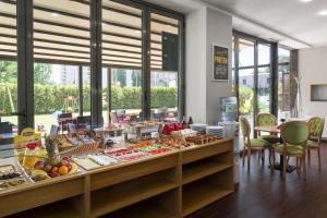 a bakery with a buffet of food on a counter at Tomis Garden Aparthotel Mamaia in Mamaia