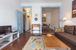 a living room with a couch and a table at Alfama Tailor Made Blue House With a View #1 in Lisbon