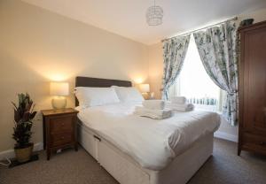 a bedroom with a bed with two towels on it at The Royal Oak Pub in Lampeter