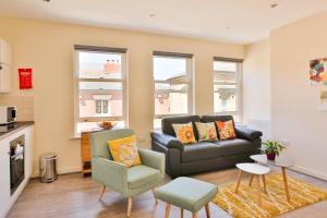 a living room with a couch and a chair at The Nest in Sheffield
