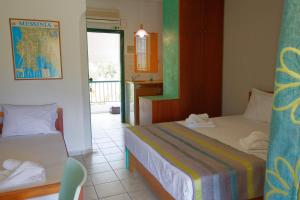 A bed or beds in a room at Athina Rooms