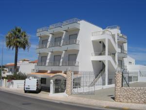a white building with a van parked in front of it at Residencial Campo-Mar by Umbral in Portimão