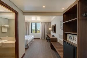 Cama ou camas em um quarto em Linx Confins