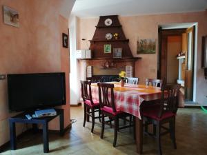 a dining room with a table and a tv at Campino in Stresa
