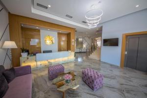 a lobby with purple chairs and a table in a building at Sole Luna Hotel in Borsh