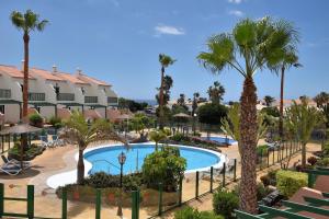 a view of a resort with a pool and palm trees at Las Adelfas 2 in San Miguel de Abona