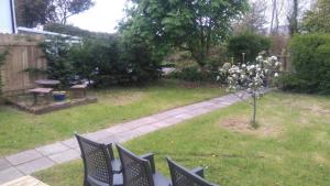 a garden with chairs and a tree in the grass at Murrevagh Mealog in Tooreen